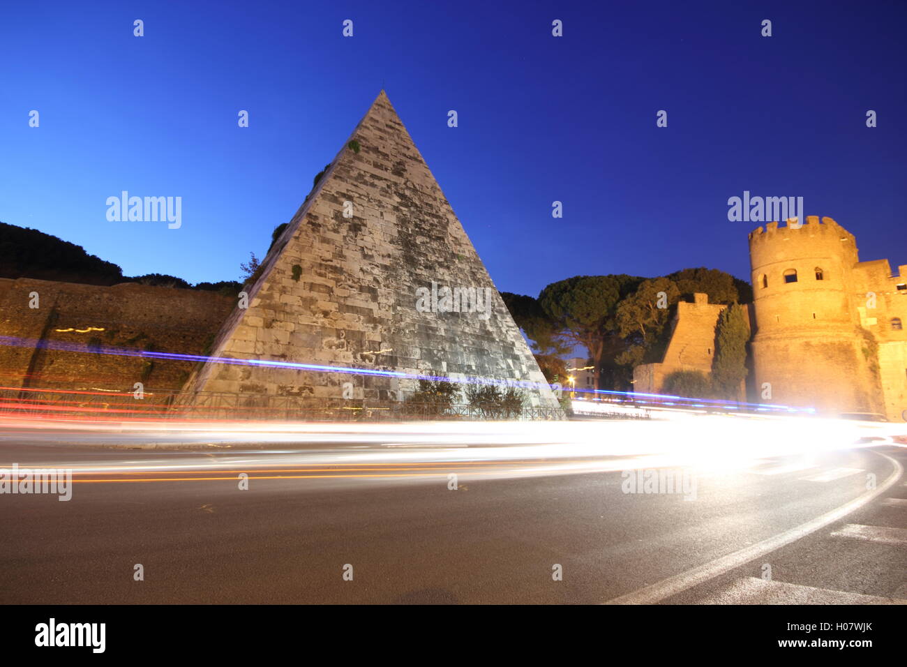 a stunning shot of the Egyptian style pyramid in the city of Rome by night, 'Piramide Cestia', Rome, Italy Stock Photo