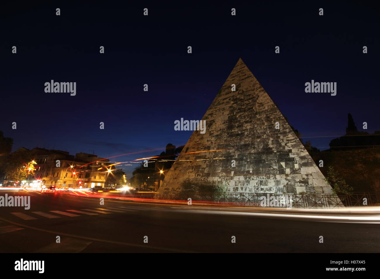 a stunning shot of the Egyptian style pyramid in the city of Rome by night, 'Piramide Cestia', Rome, Italy Stock Photo