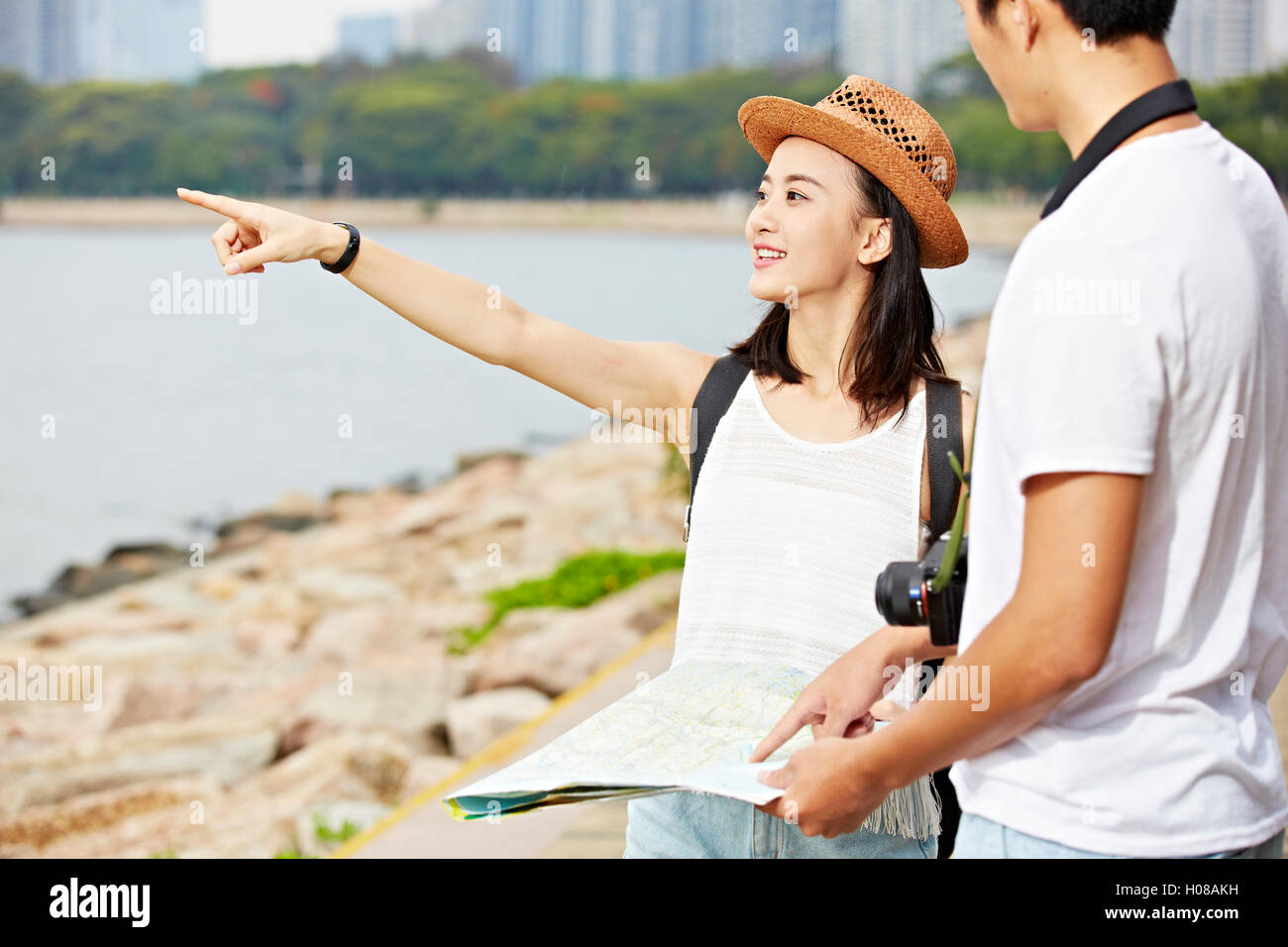 young asian couple tourists trying to locate a scenery spot using a map Stock Photo