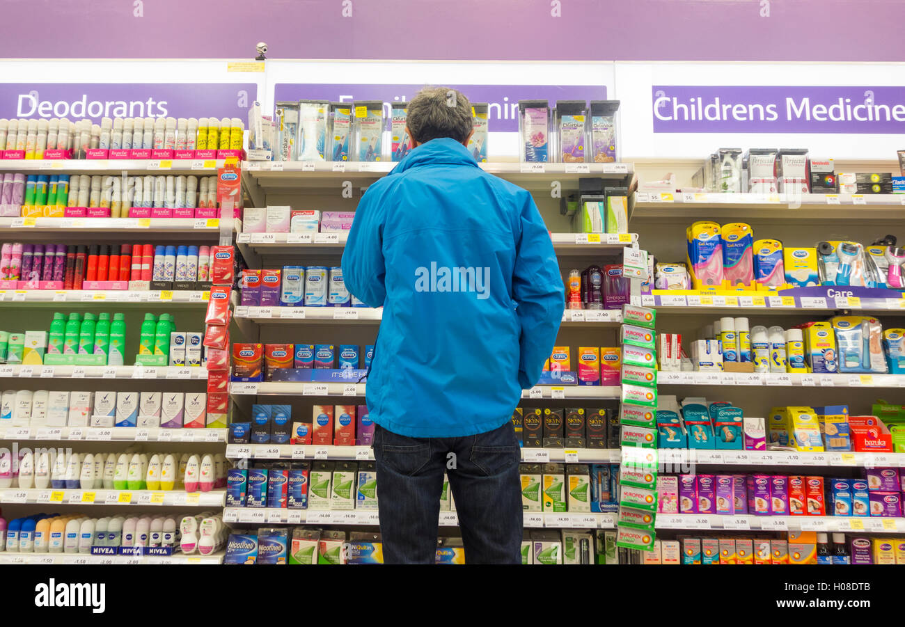 Man looking at Family planning (condoms) display in supermarket. UK Stock Photo