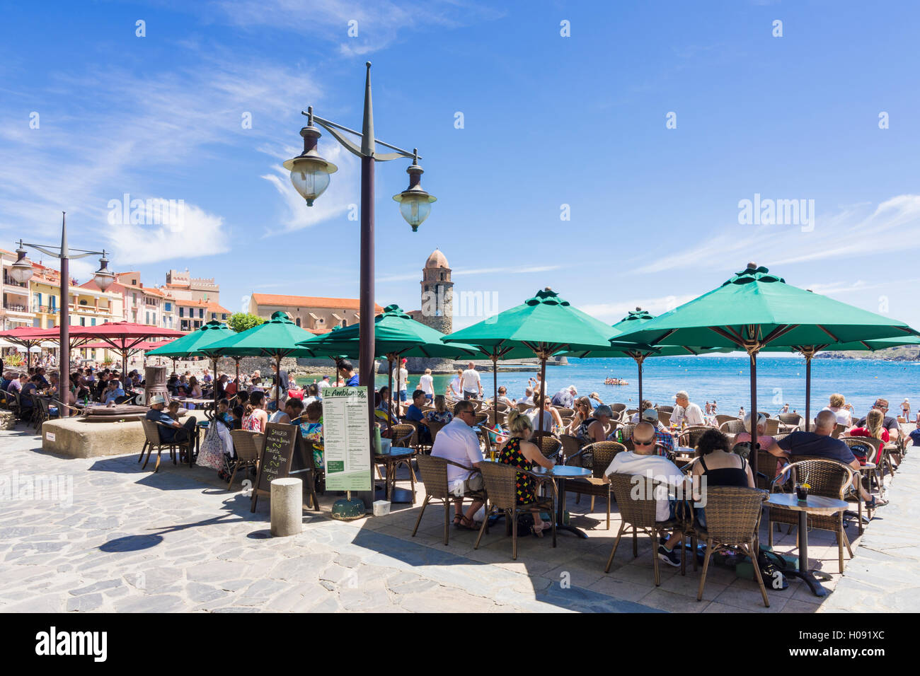 Busy cafe bar along the waterfront promenade of Collioure, Côte Vermeille, France Stock Photo