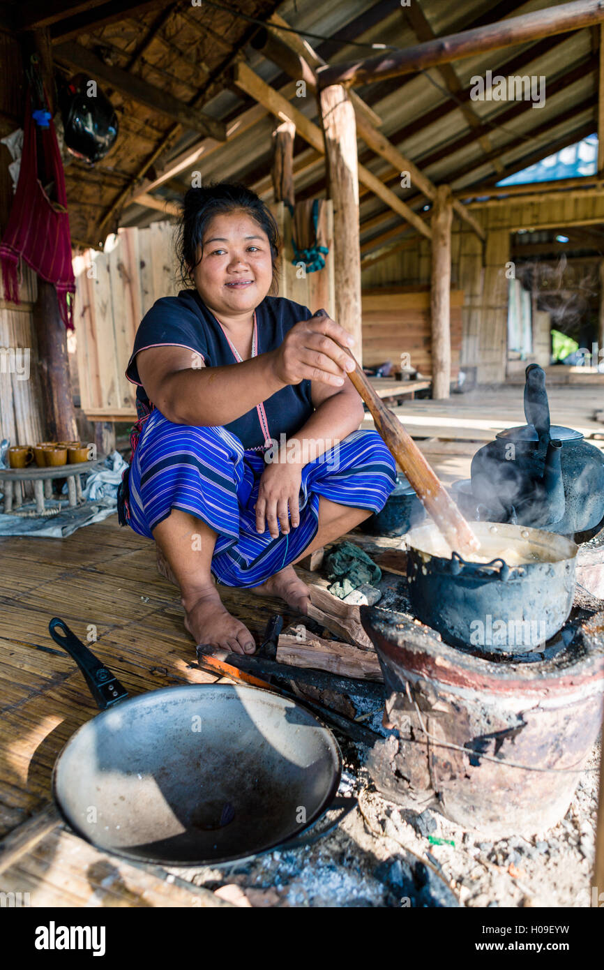 Indigenous White Karen hill tribe villager cooking at a traditional stove, Doi Inthanon, Chiang Mai, Thailand Stock Photo