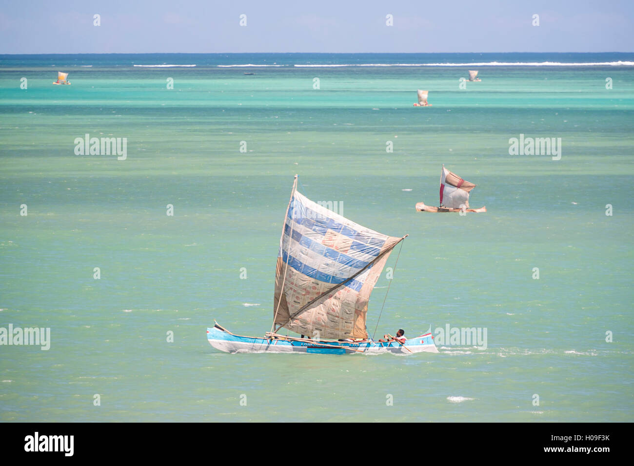 Fisherman fishing from a Pirogue, a traditional Madagascar sailing boat, Ifaty, Madagascar, Africa Stock Photo