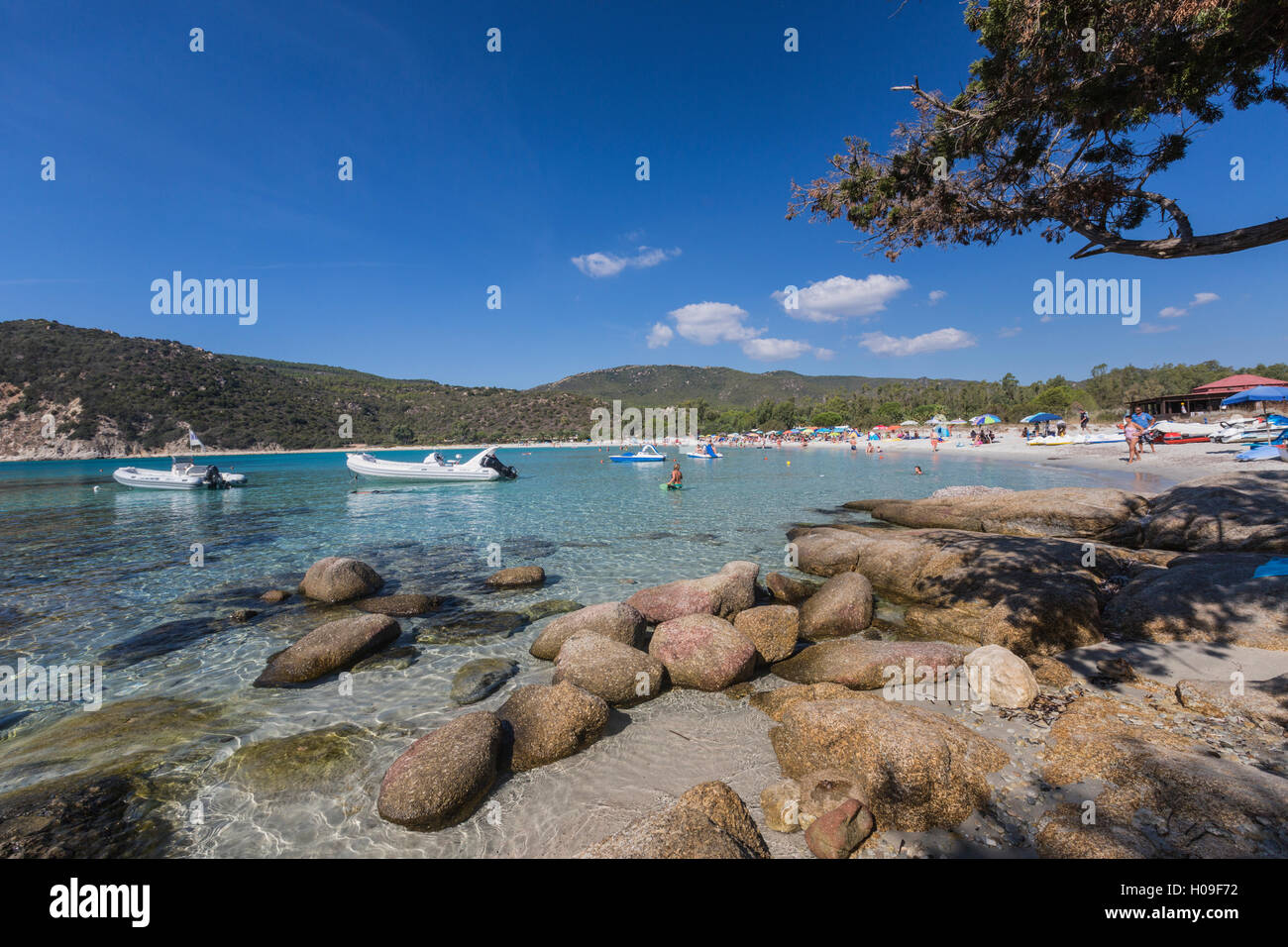 Boats in the turquoise sea surround the sandy beach of Cala Pira Castiadas, Cagliari, Sardinia, Italy, Mediterranean, Europe Stock Photo