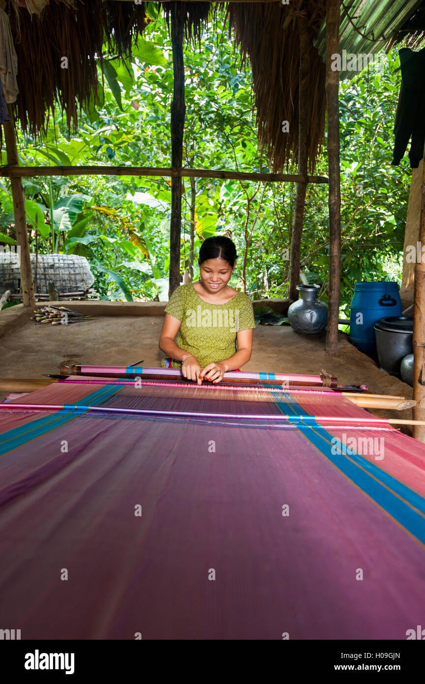 A woman weaves traditional fabric using a hand loom, Chittagong Hill Tracts, Bangladesh, Asia Stock Photo