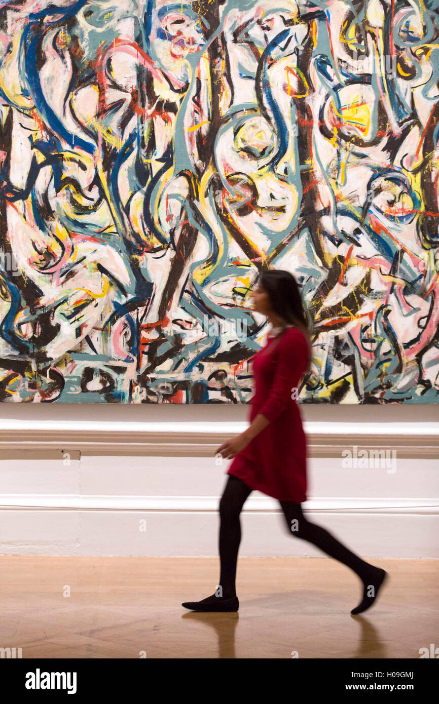 A woman walks past 'Mural', 1943 by Jackson Pollock during a photocall