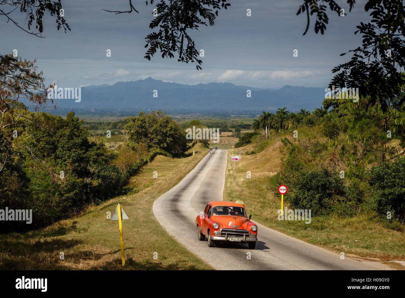 Old vintage American car on a road outside Trinidad, Sancti Spiritus Province, Cuba, West Indies, Caribbean, Central America Stock Photo