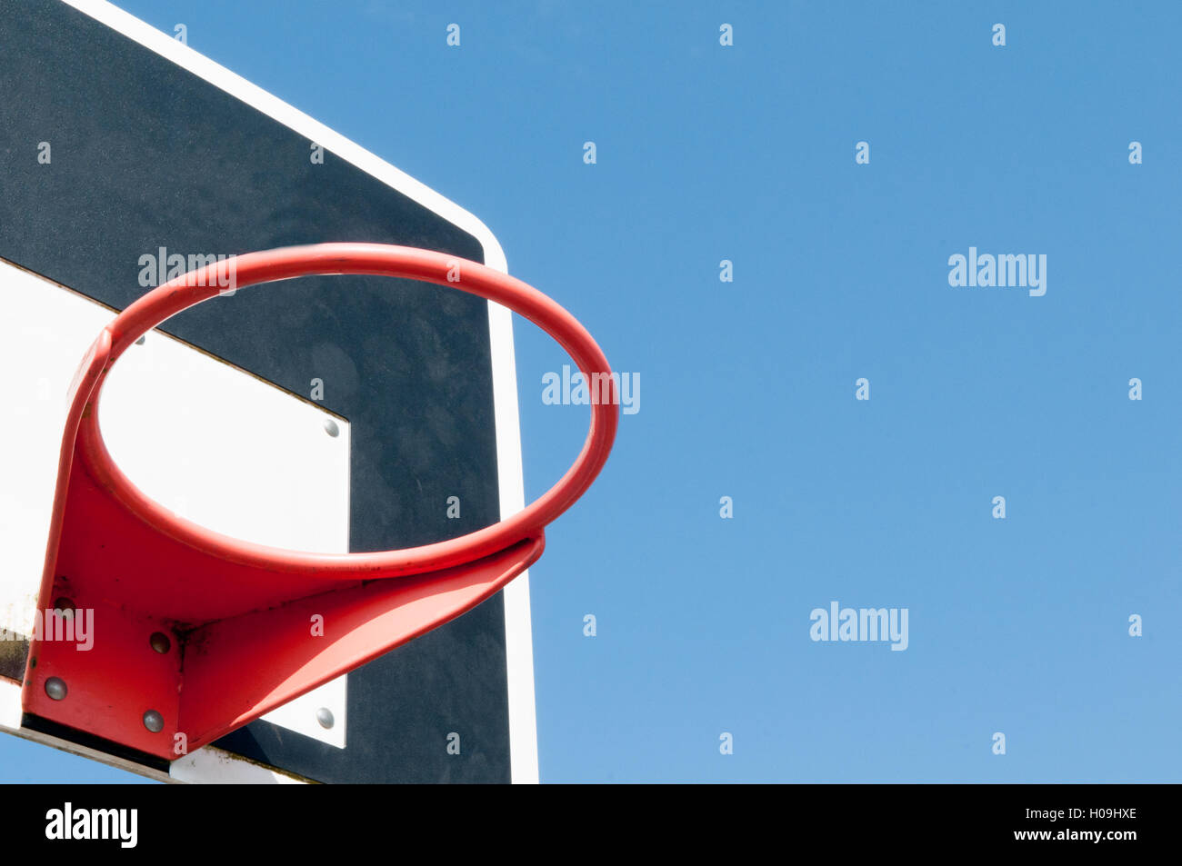 Basketball hoop outside with blue sky background Stock Photo