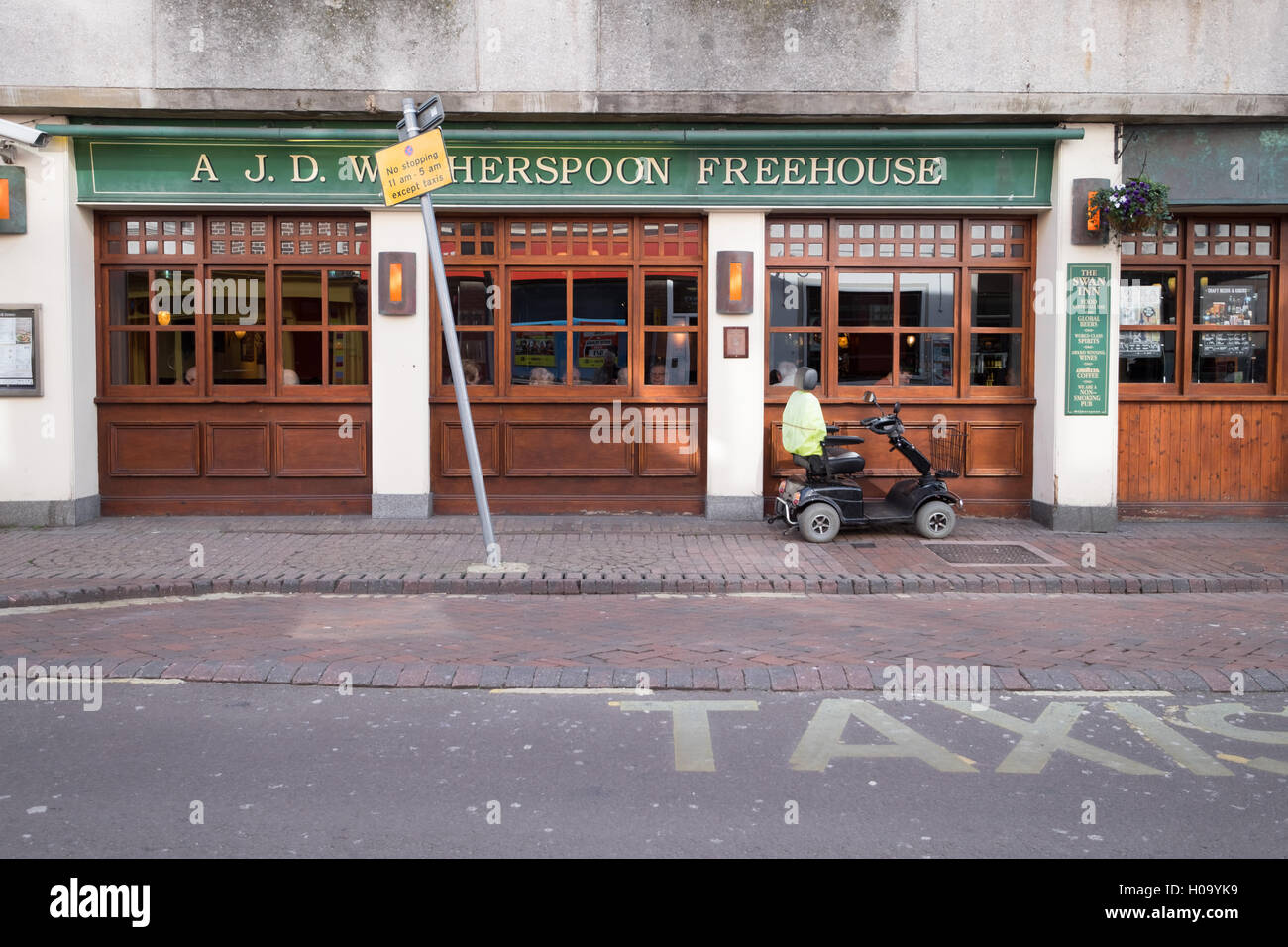 mobility scooter outside wetherspoons pub Stock Photo