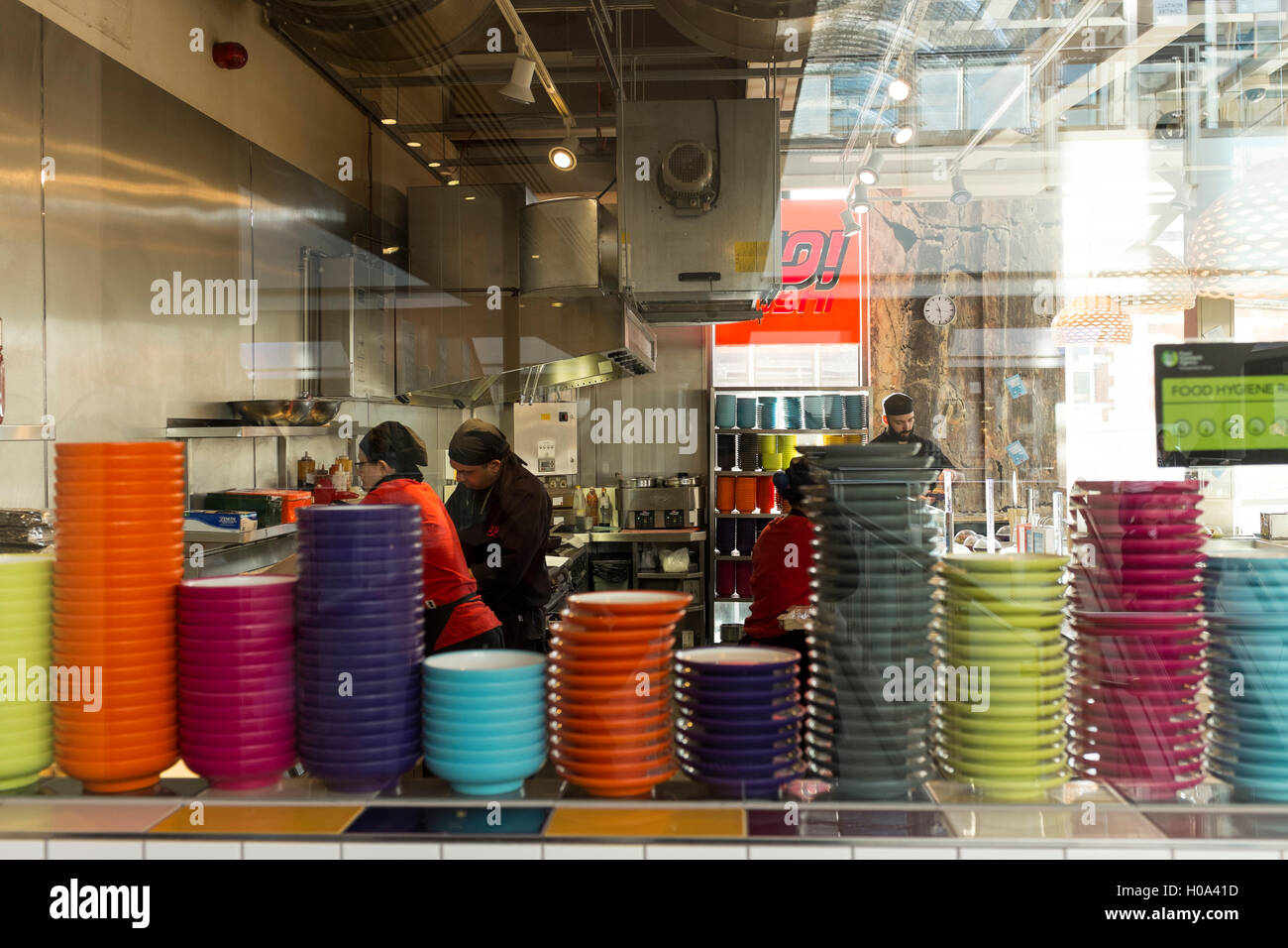 Stacks of different colour plates at Yo Sushi Restaurant, Kingston upon Thames, Surrey Stock Photo