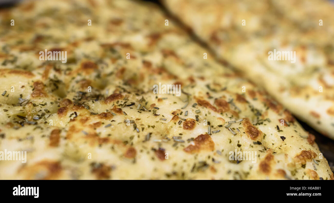 Freshly baked Garlic and herb flat bread Stock Photo Alamy