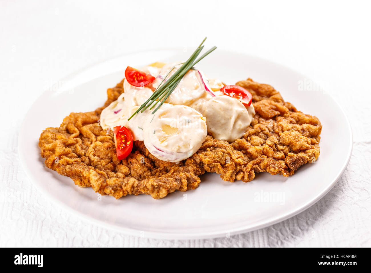 Large wiener schnitzel with potatoes salad Stock Photo