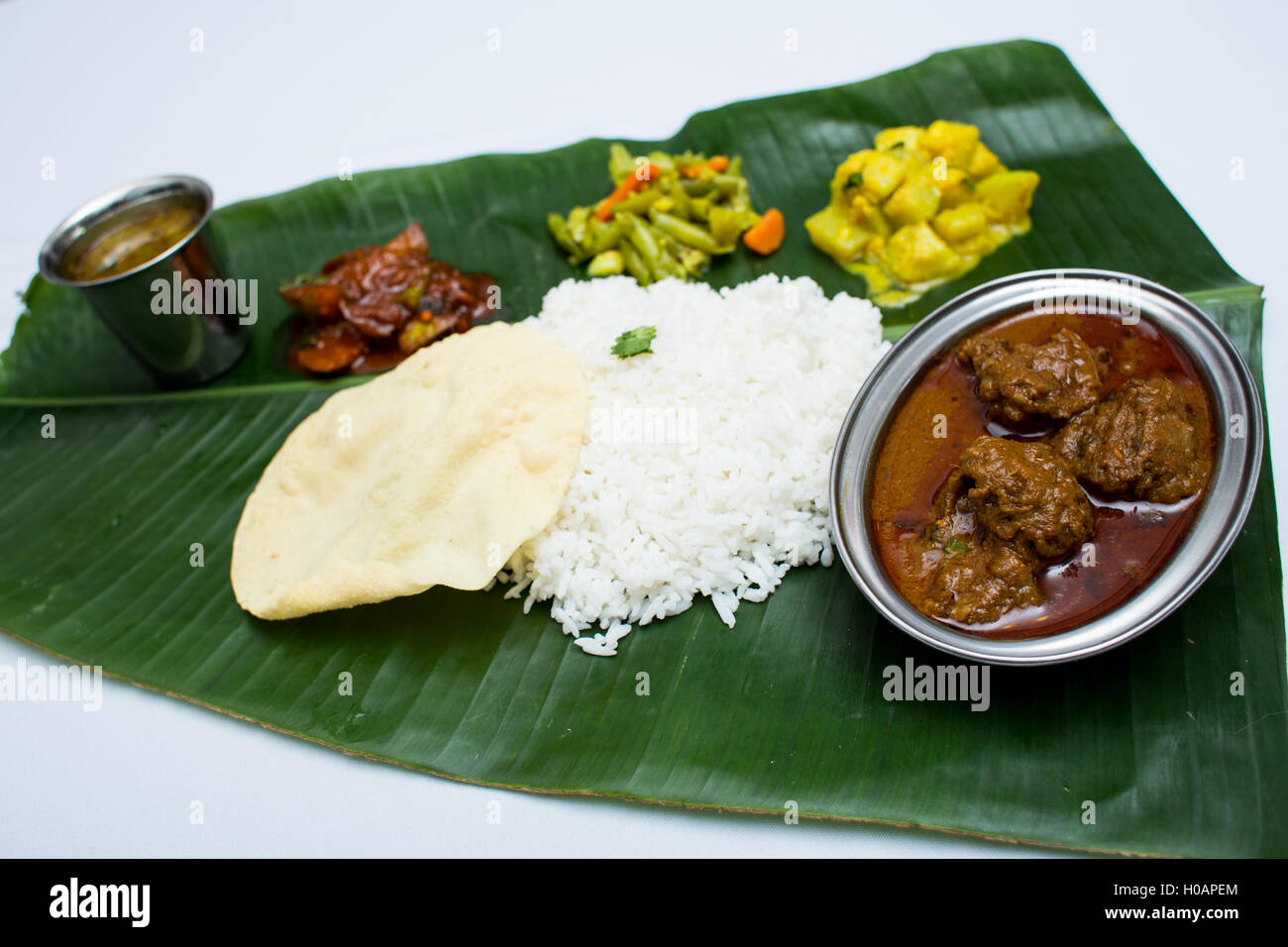 Motton Rice Indian mutton with plain rice on banana leaf tray Stock Photo - Alamy