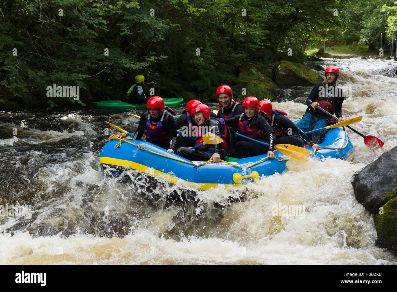 White water rafters being tossed in the rapids at the National White Water Centre on the River Tryweryn outside Bala North Wales Stock Photo