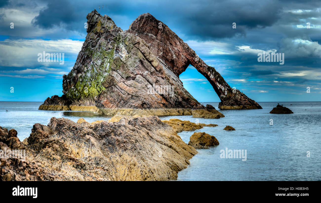 Bow Fiddle Rock, a natural sea arch near Portknockie on the Moray coast. Stock Photo
