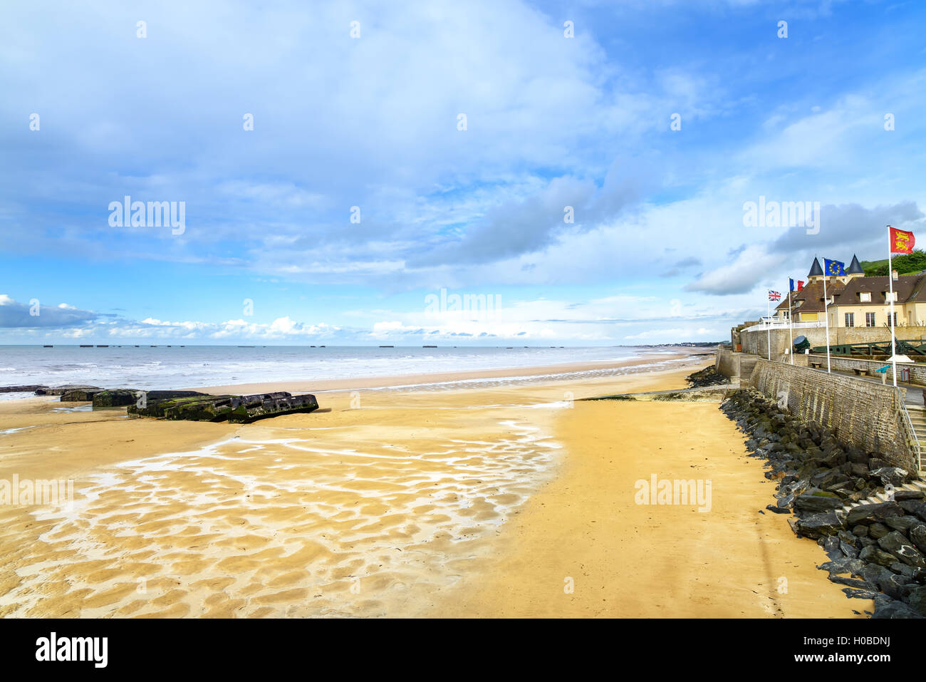 Arromanches les Bains, seafront beach and remains of the artificial harbour, used on D-Day in World War II. Normandy, France. Stock Photo