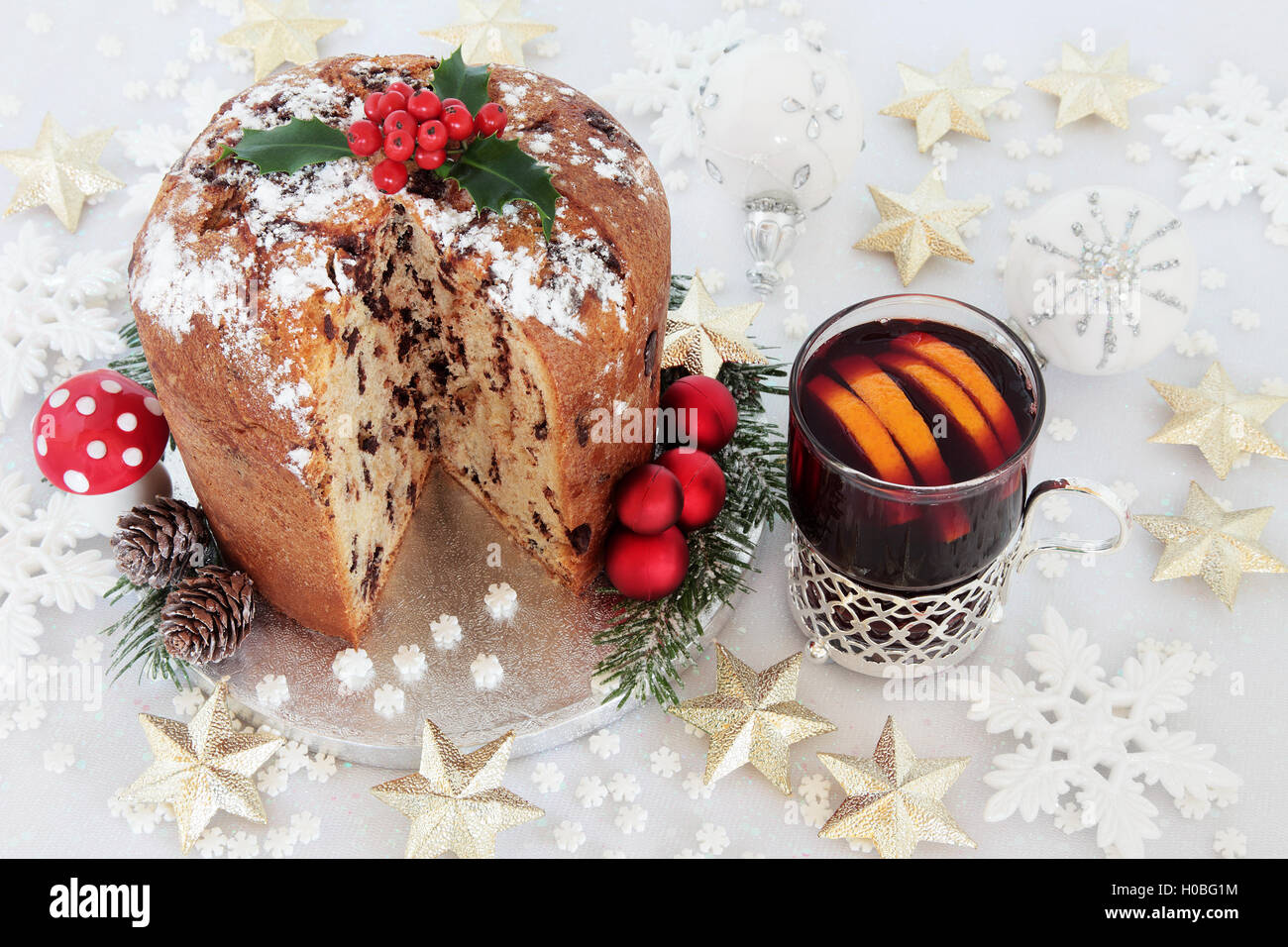 Chocolate panettone christmas cake with mulled wine and star,snowflake and round shaped bauble decorations. Stock Photo