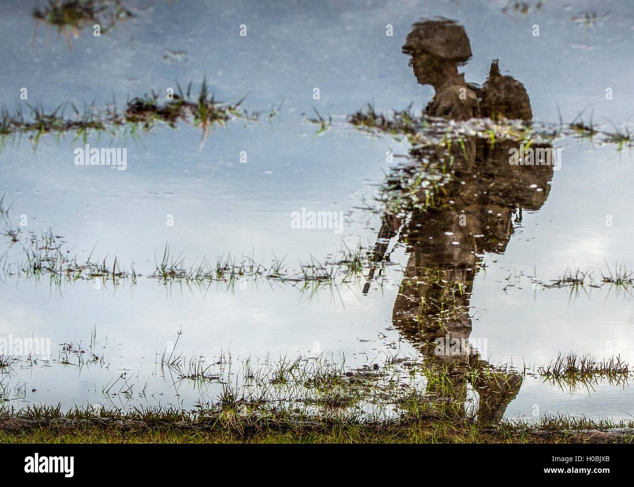 Reflection in the water of U.S. Marine recruit marching during tactical training at the Marine Corps Recruit Depot December 3, 2015 in Parris Island, South Carolina. Stock Photo