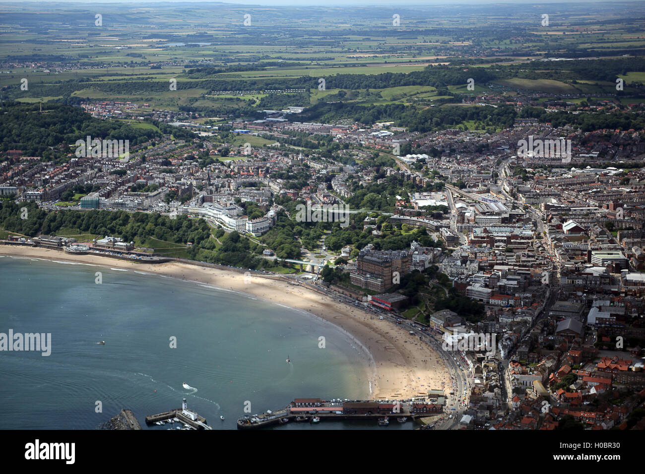 Aerial photo South cliff Scarborough and town center taken from over the sea.  Shows countryside in background. Stock Photo