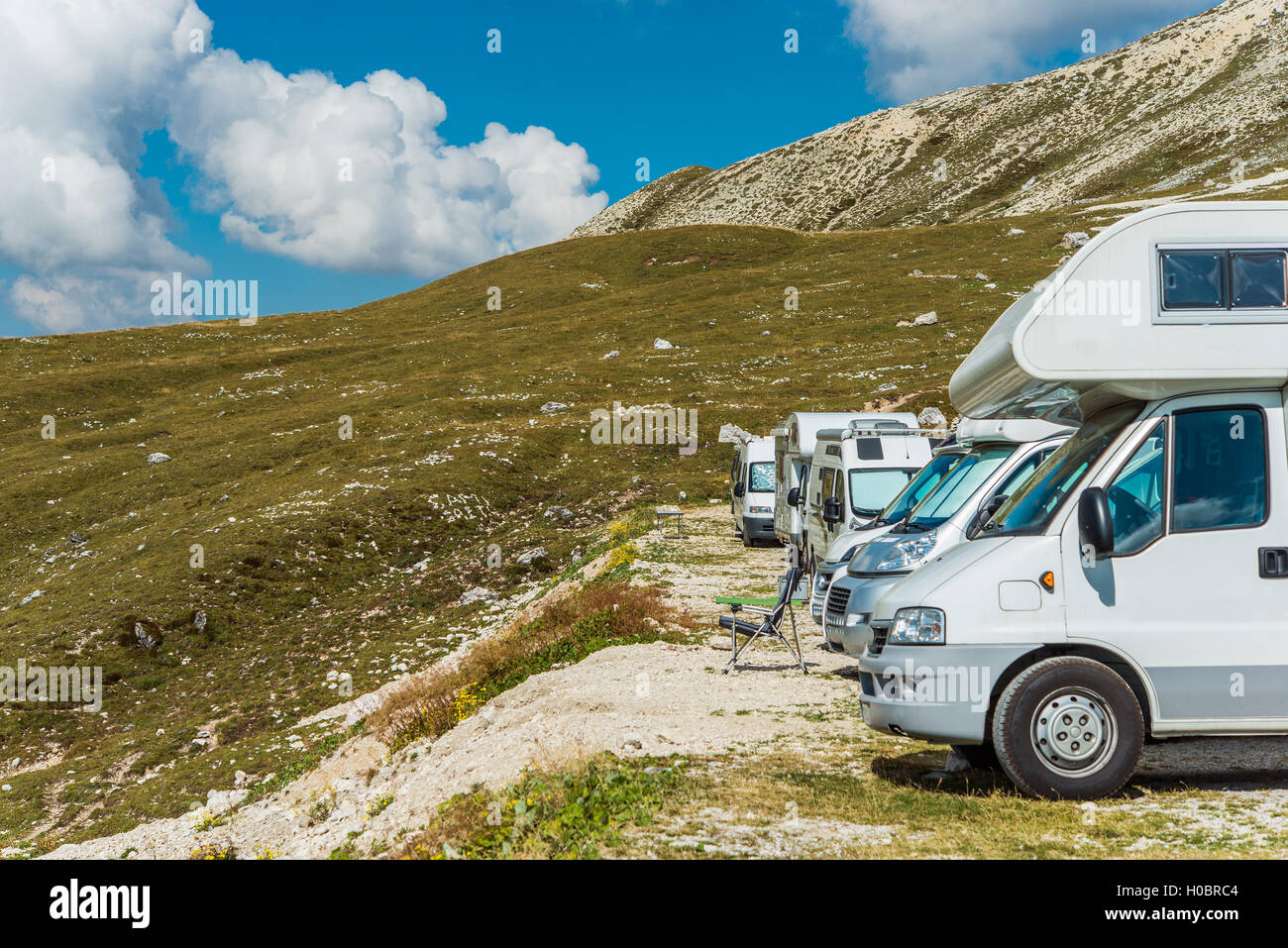 RV Motorhomes Camping in High Alpine Place. Scenic Campers Campground. Stock Photo