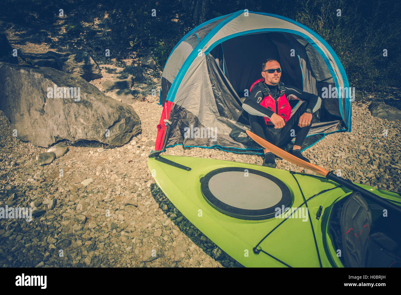Lake Shore Camping Place. Men Camping on the Lake Shore and Taking Kayak Trips. Outdoor Lifestyle. Stock Photo