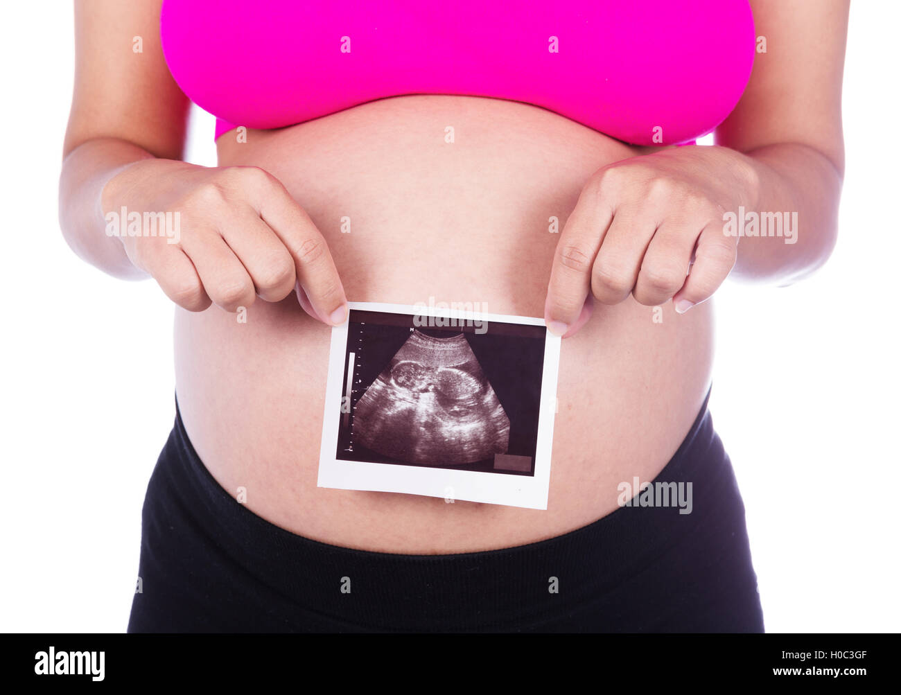 Pregnant woman hands holding ultrasound photo isolated on white background Stock Photo