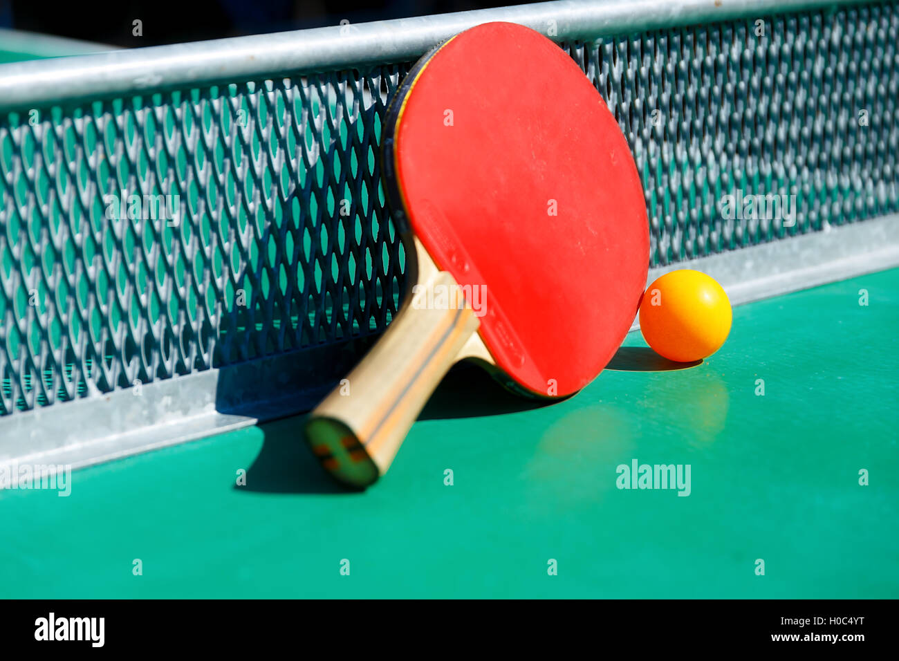 details of pingpong table with playing equipment and yellow ball Stock Photo