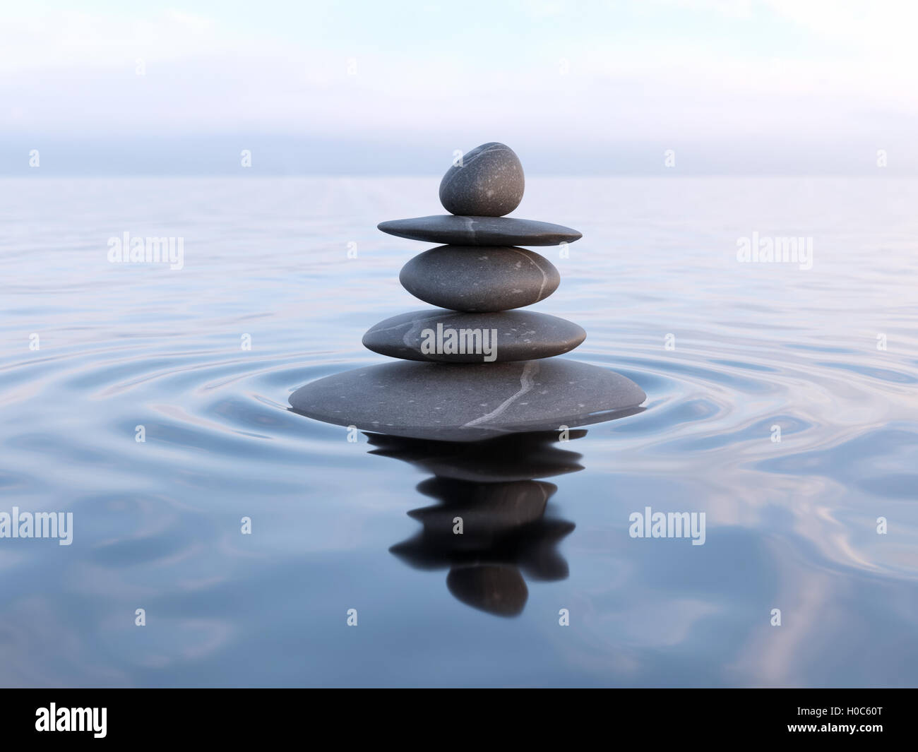 Balanced Zen stones in water Stock Photo - Alamy