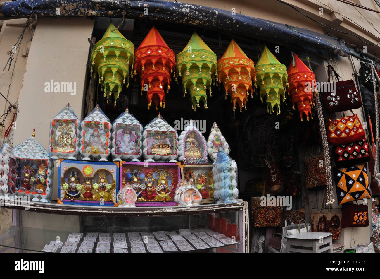 Puri, Odisha, India - July 3, 2011 : Mementos of Lord Jagannath, Balbhadra and Subhadra, handicrafts and chandeliers on display. Stock Photo