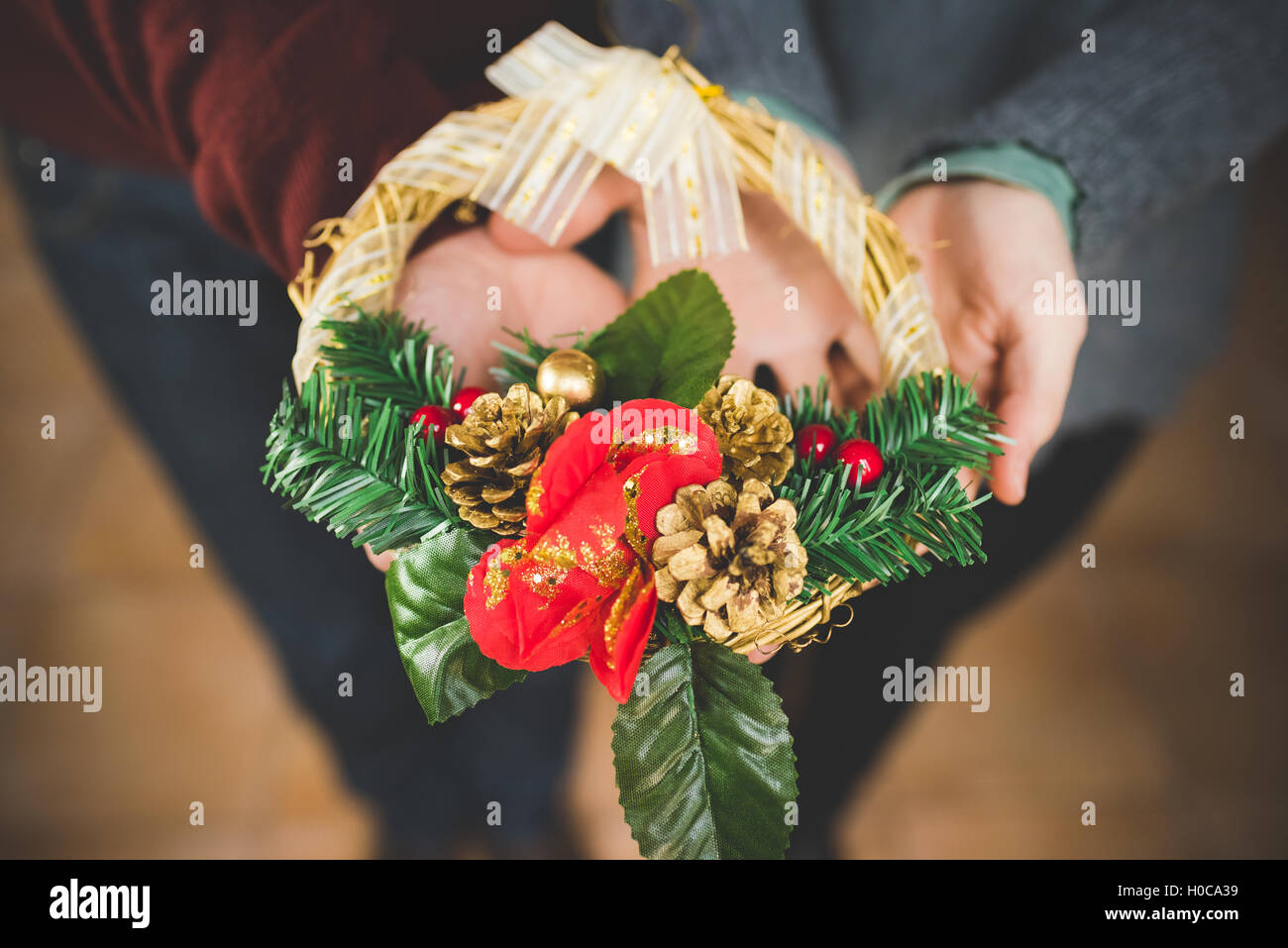 Close uo on the hands of man and woman couple holding and showing a crown decoration - christmas, decoration, celebration concep Stock Photo