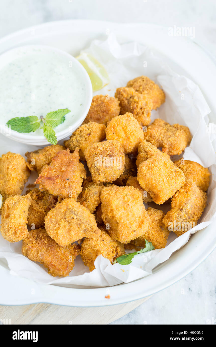 Tortilla crusted baked fish bites on white bowl Stock Photo Alamy