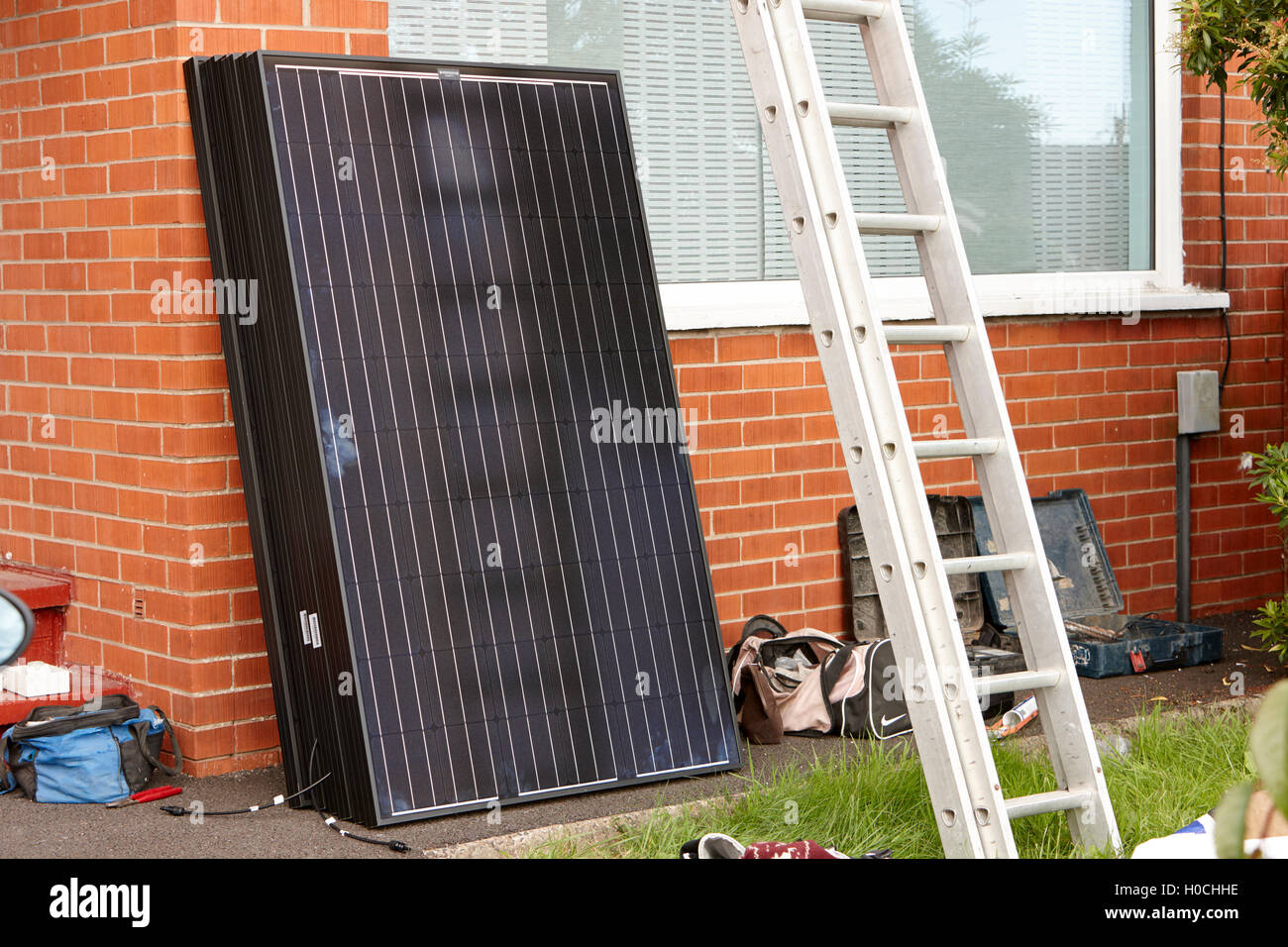 black solar panels for installation in a domestic solar panel installation in the uk Stock Photo