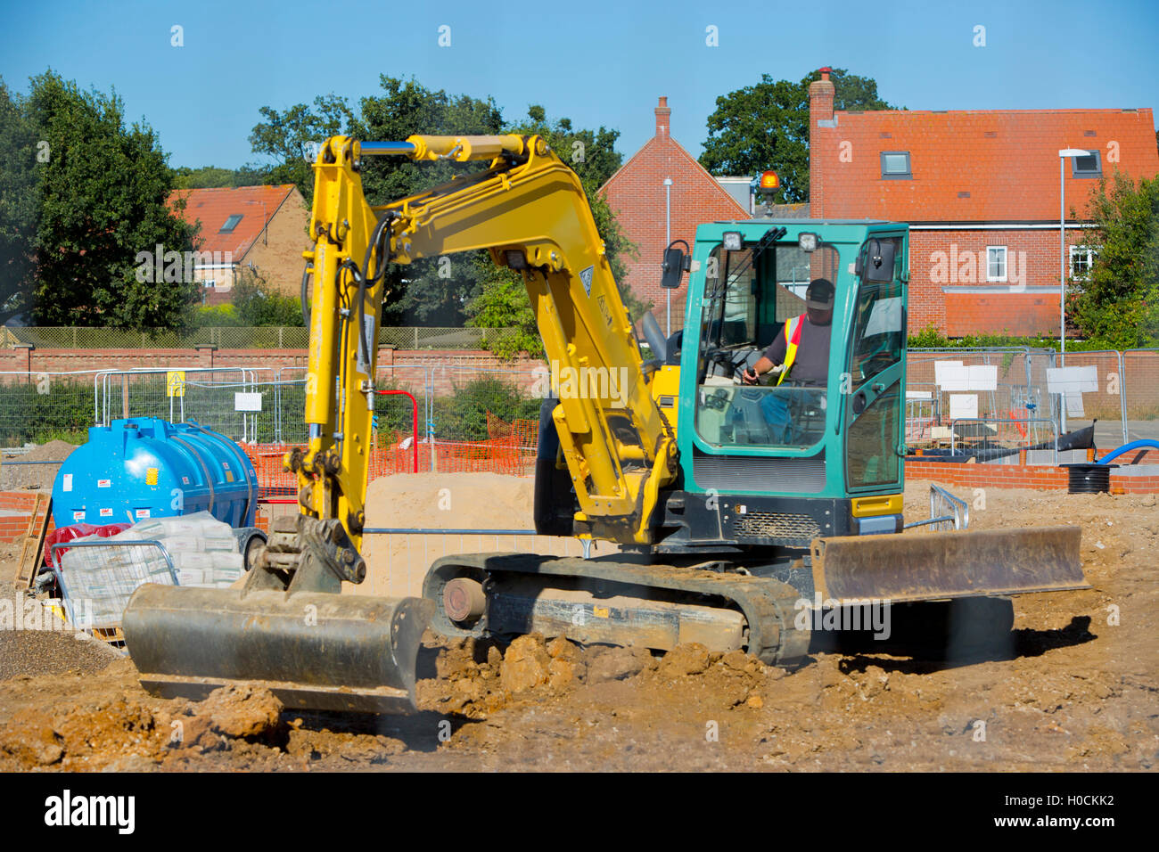 A digger working on a building site Stock Photo