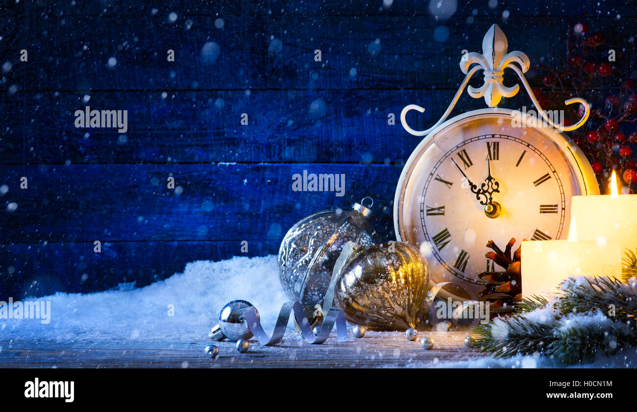 Christmas holiday eve; Christmas decoration and vinyage clock Stock Photo