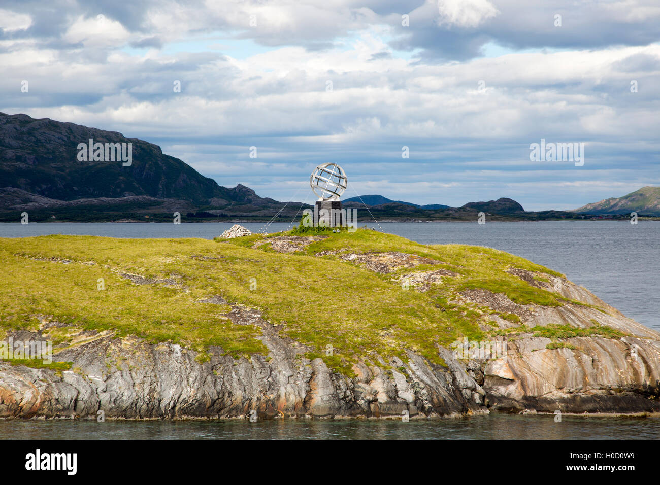 Monument marker to show crossing the Arctic Circle heading south on small  island, Norway Stock Photo