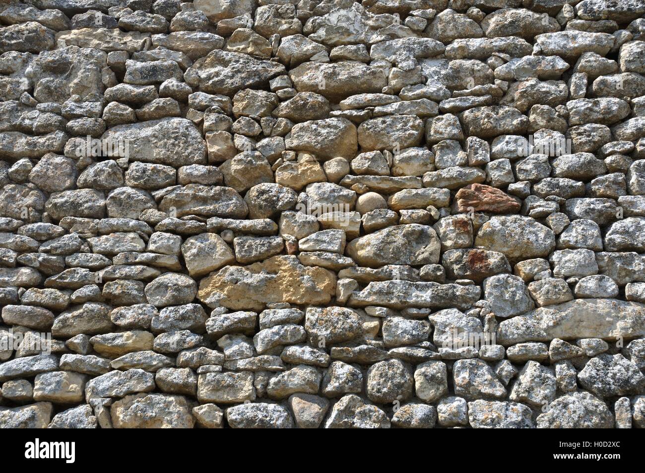 Solid wall made of stone Stock Photo - Alamy