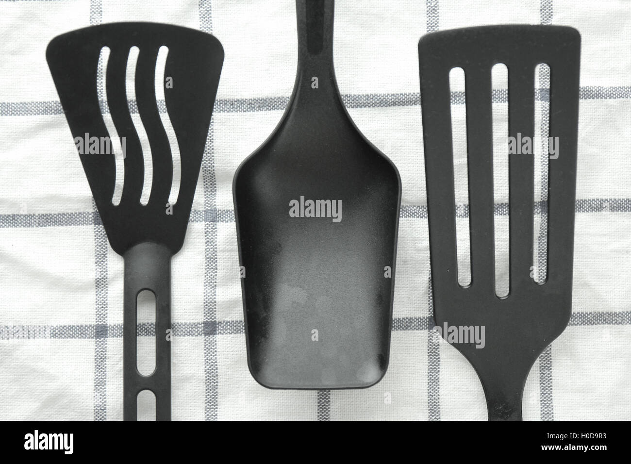 black ladle and spade of frying pan on the white table Stock Photo Alamy