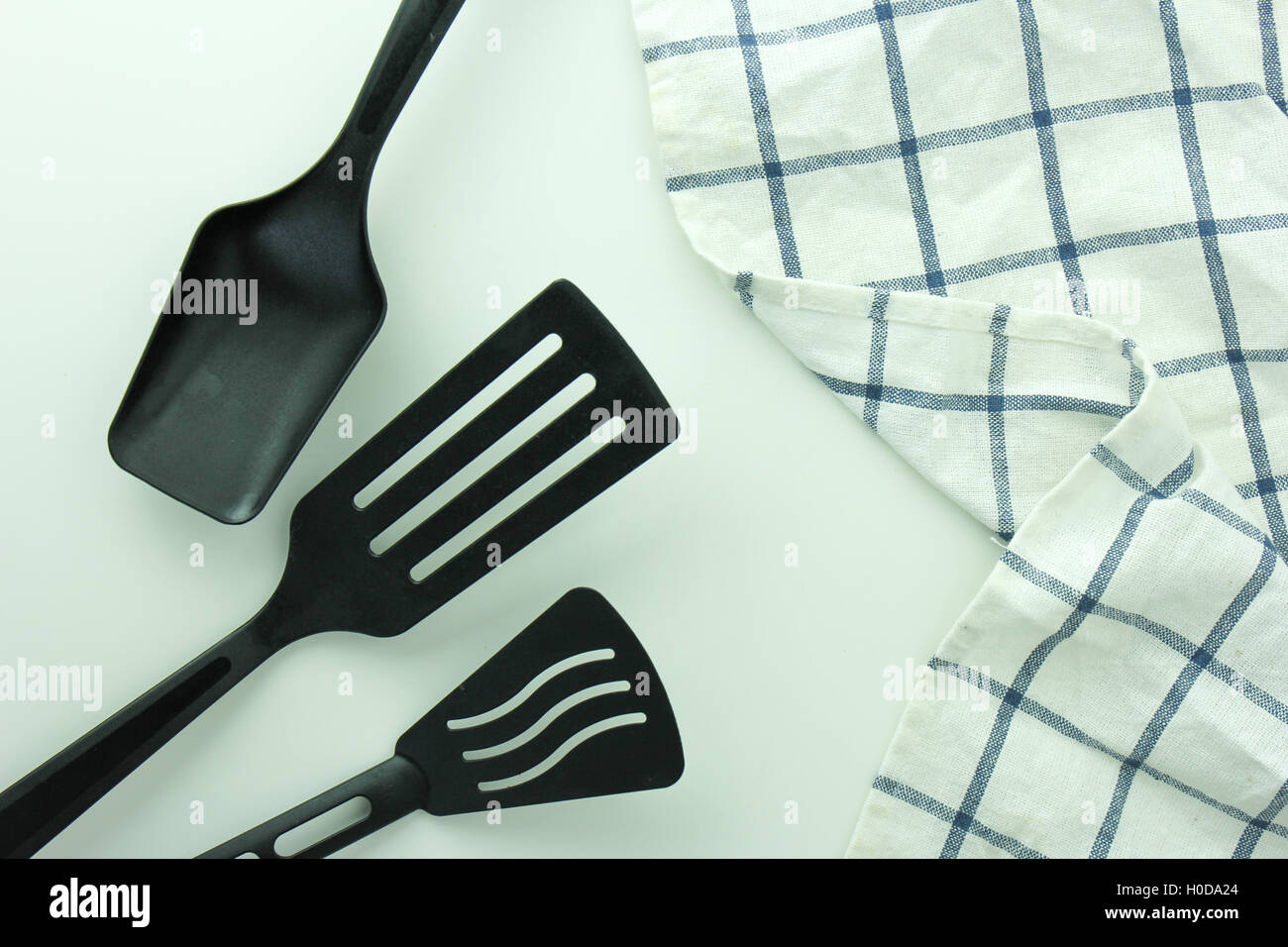 black ladle and spade of frying pan on the white table Stock Photo Alamy