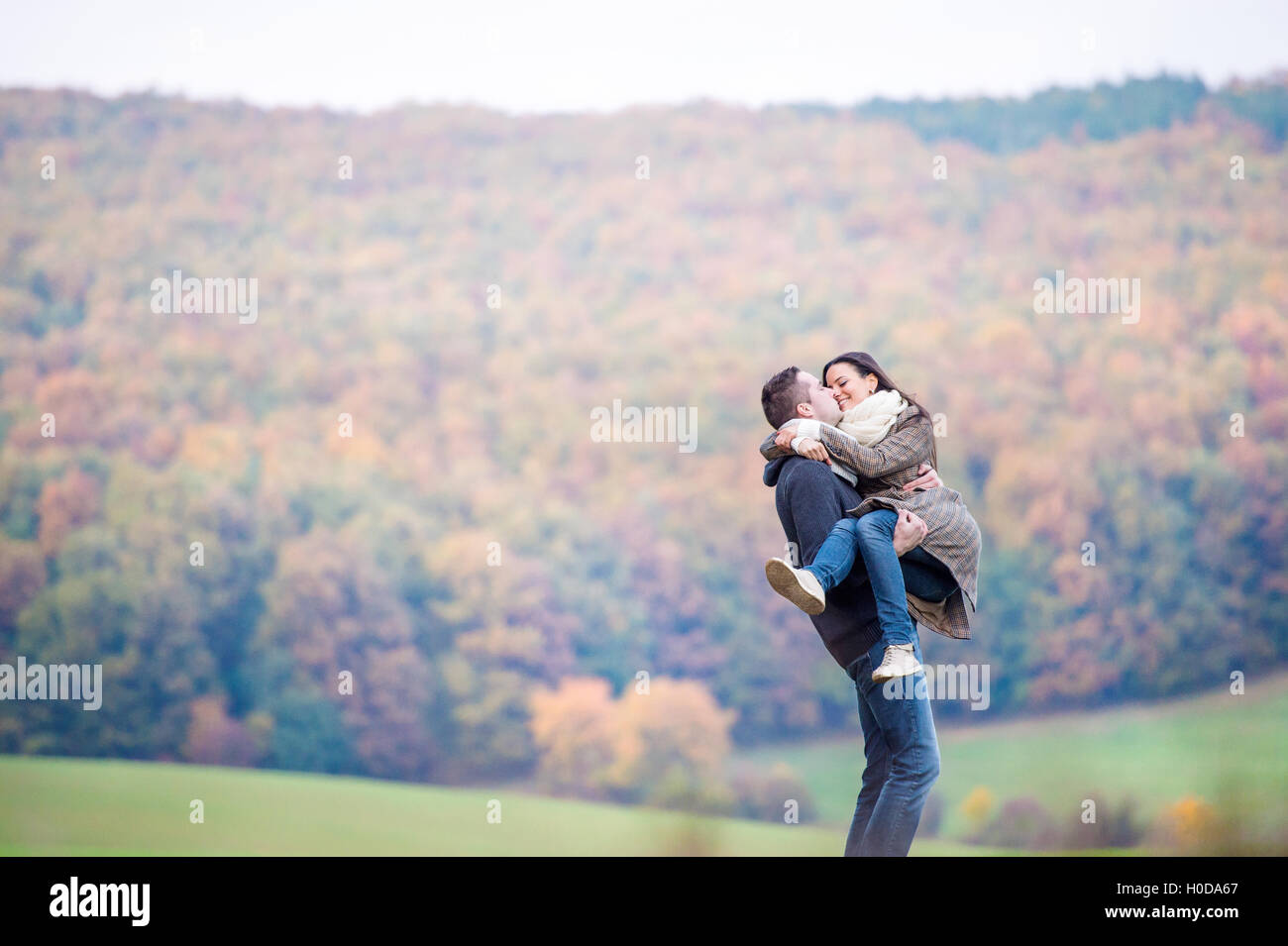 Beautiful young couple on a walk. Colorful autumn nature Stock Photo ...