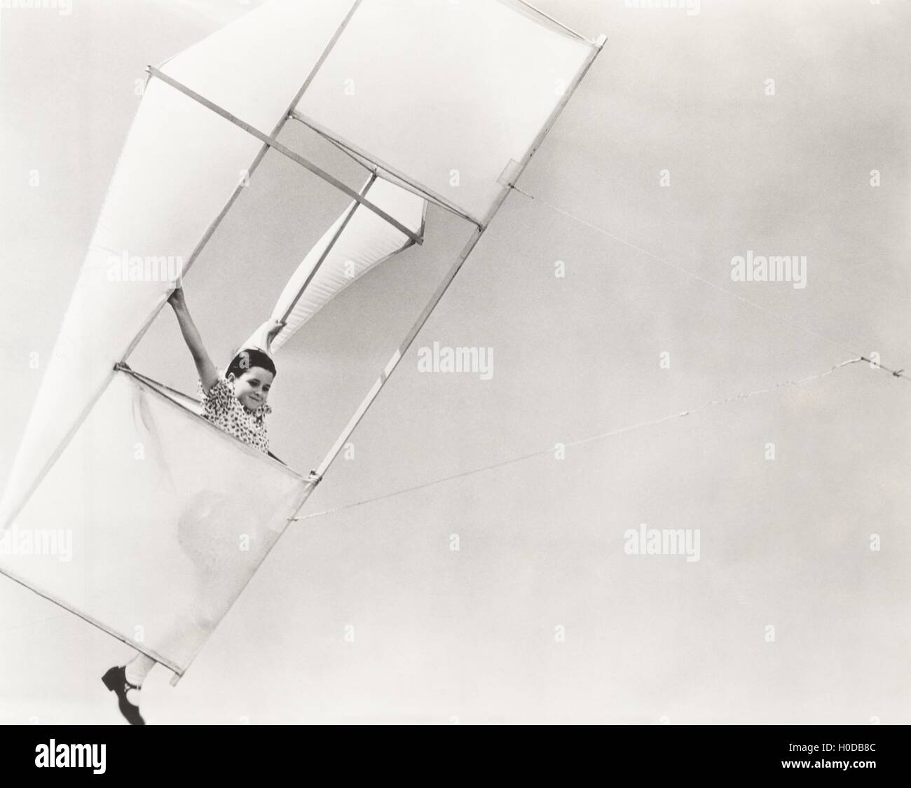 Little girl in her flying machine Stock Photo