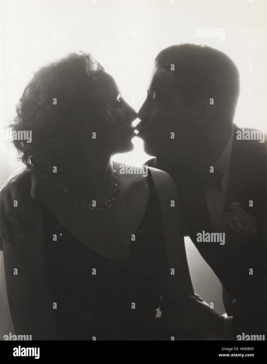 Couple kissing in silhouette Stock Photo