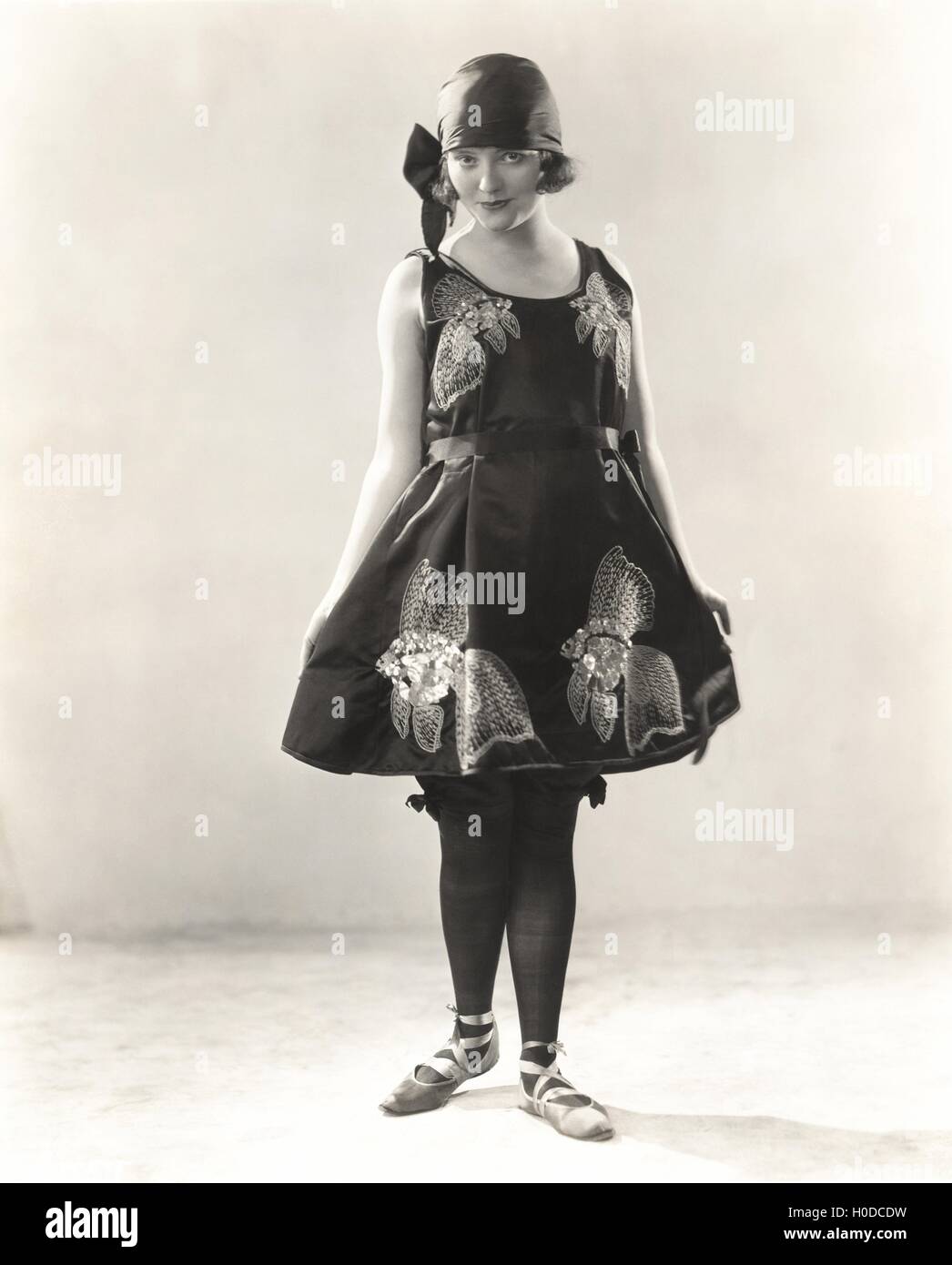 Woman wearing satin embroidered beach costume, 1920s Stock Photo