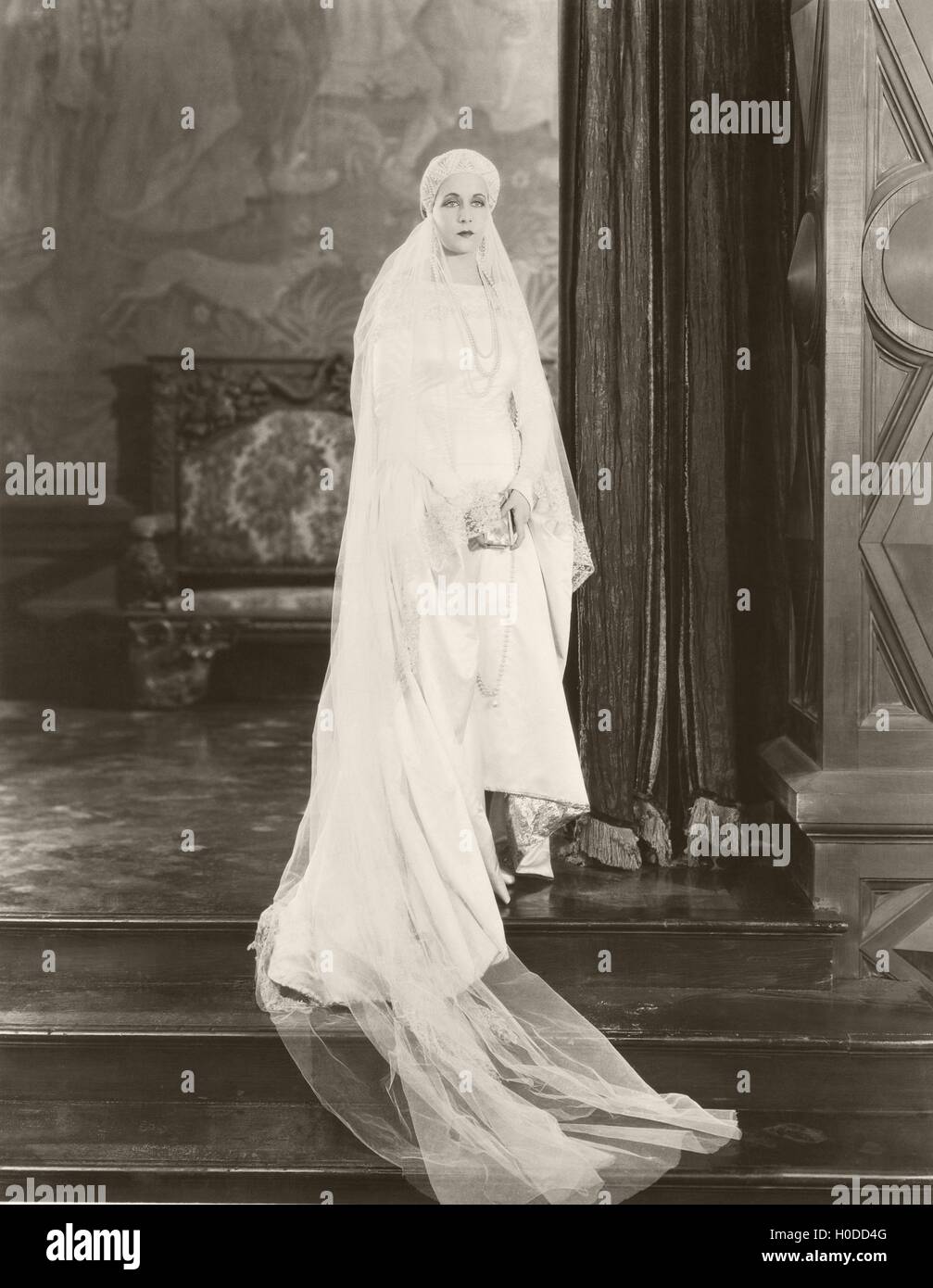 Bride posing on top of steps Stock Photo - Alamy