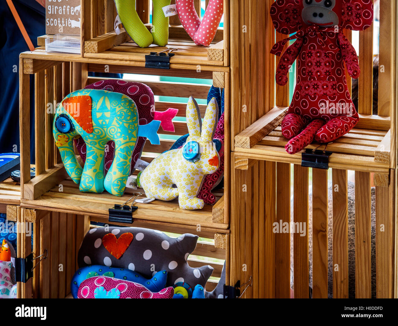 Handmade children's dolls and toys on sale in a market stall Stock