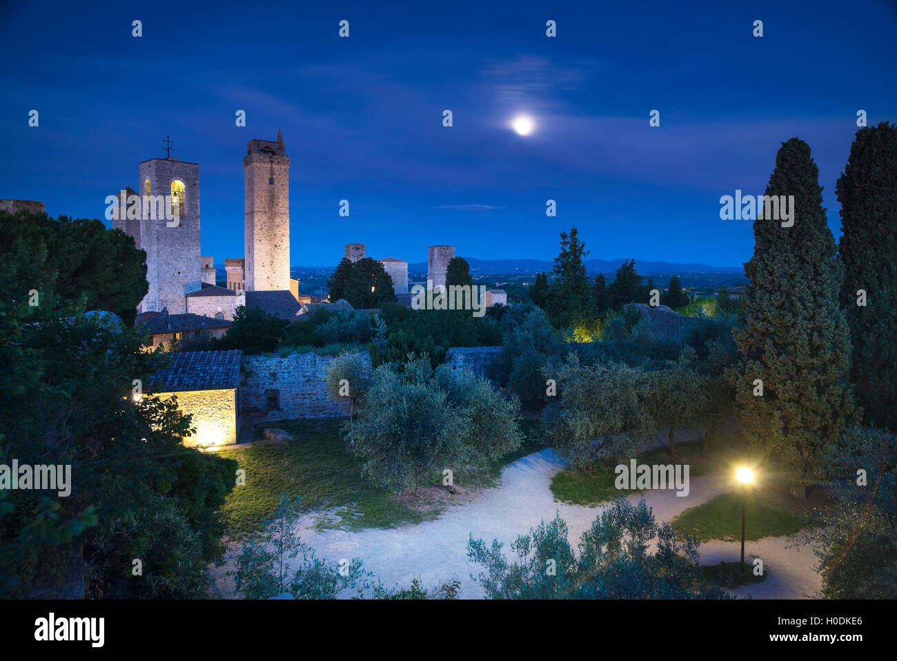San Gimignano on night, medieval town landmark. Moon light on towers and park with cypress and olive trees. Tuscany, Italy, Euro Stock Photo