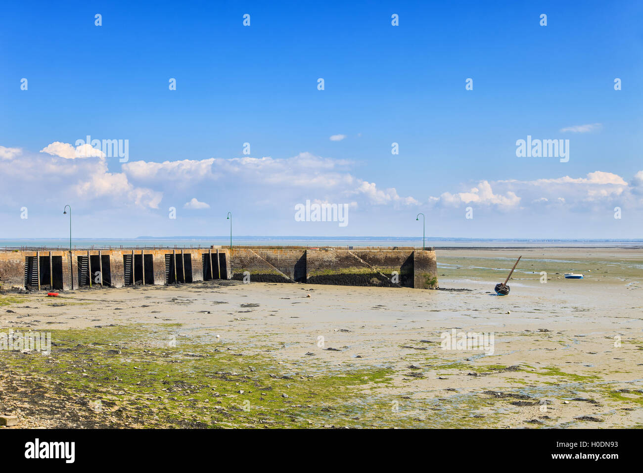 Low tide in Cancale fishing port. Pier and boat. Brittany, France. Europe. Stock Photo