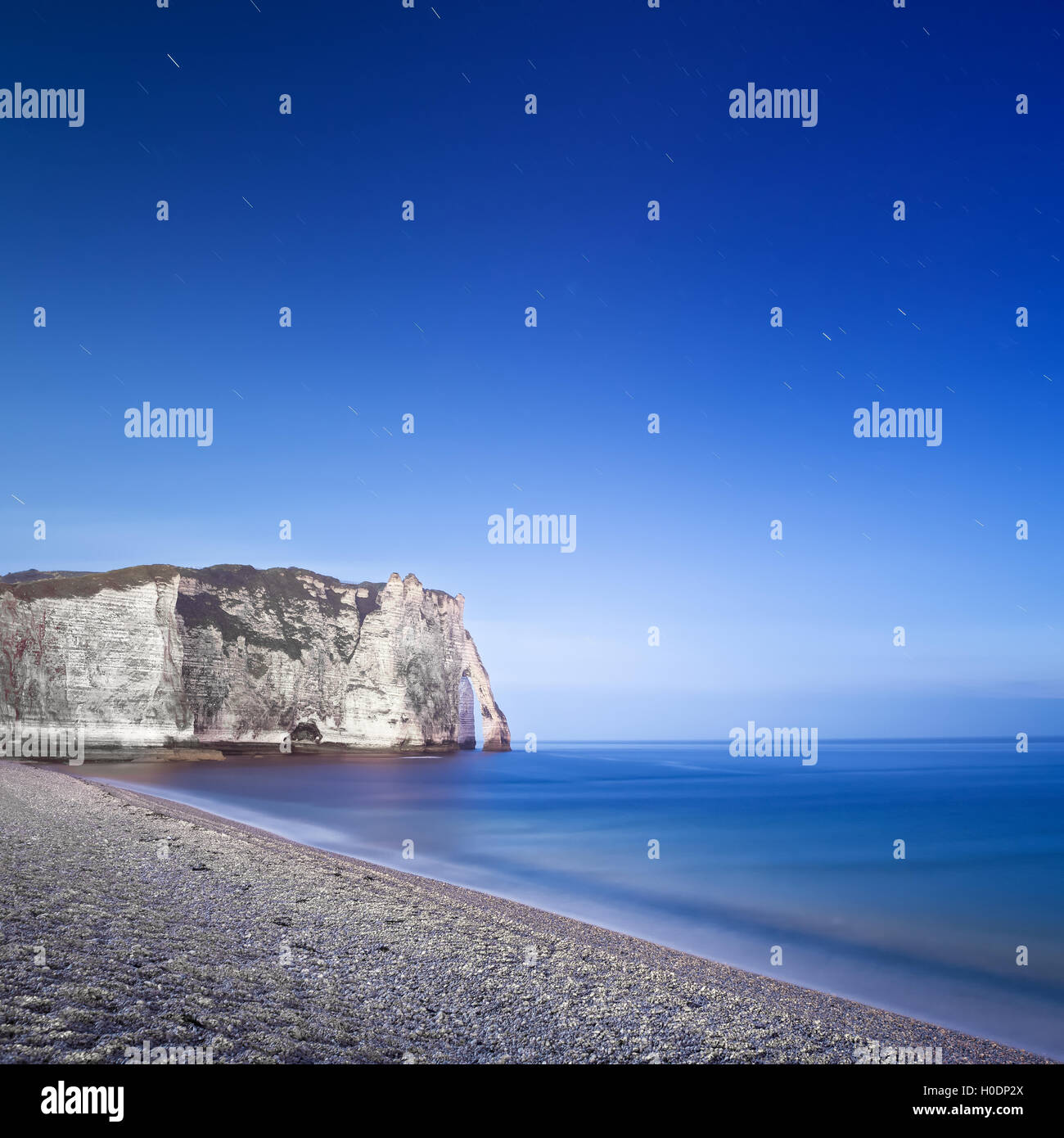 Etretat Aval cliff landmark and its beach Starring night photography. Normandy, France, Europe. Long exposure. Stock Photo