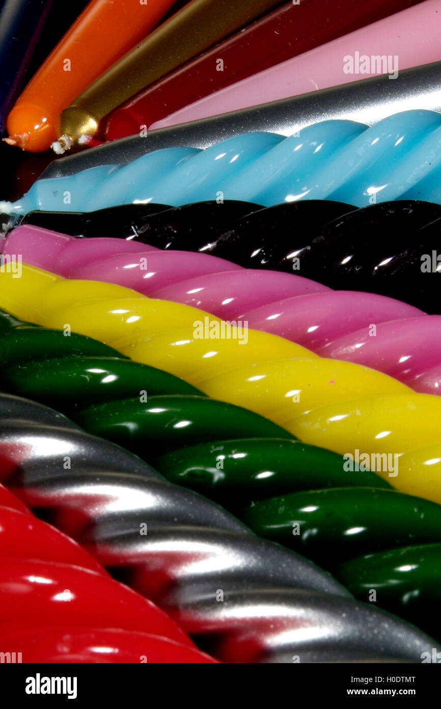 Group of colorful candles on a black background Stock Photo - Alamy