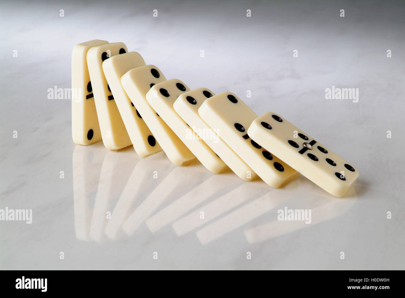 group dominoes fall on a neutral background Stock Photo - Alamy