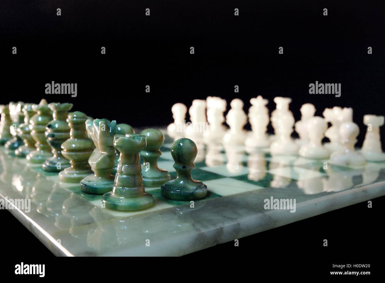 chessboard and alabaster chess on a black background Stock Photo - Alamy